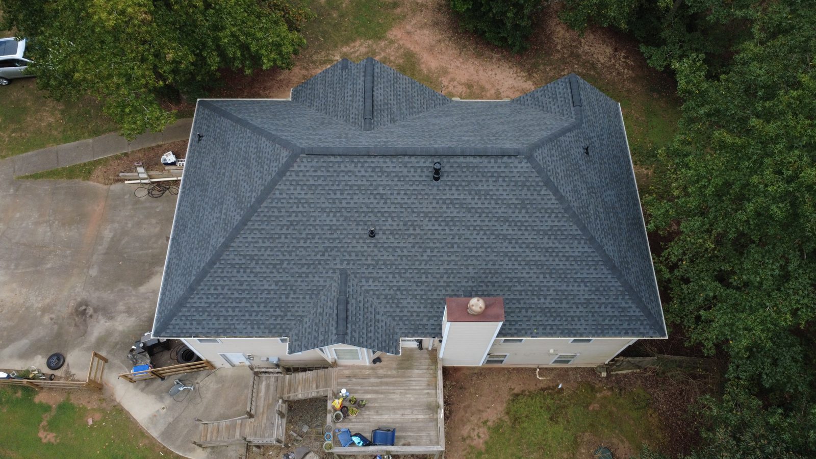 After: aerial view of the home with its new charcoal architectural shingle roof